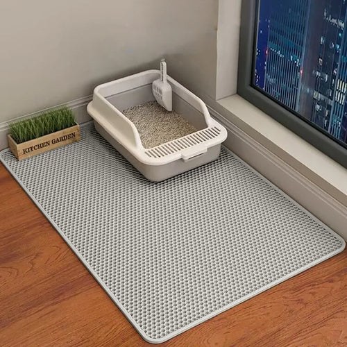 Grey double-layer honeycomb cat litter mat shown beside a litter tray