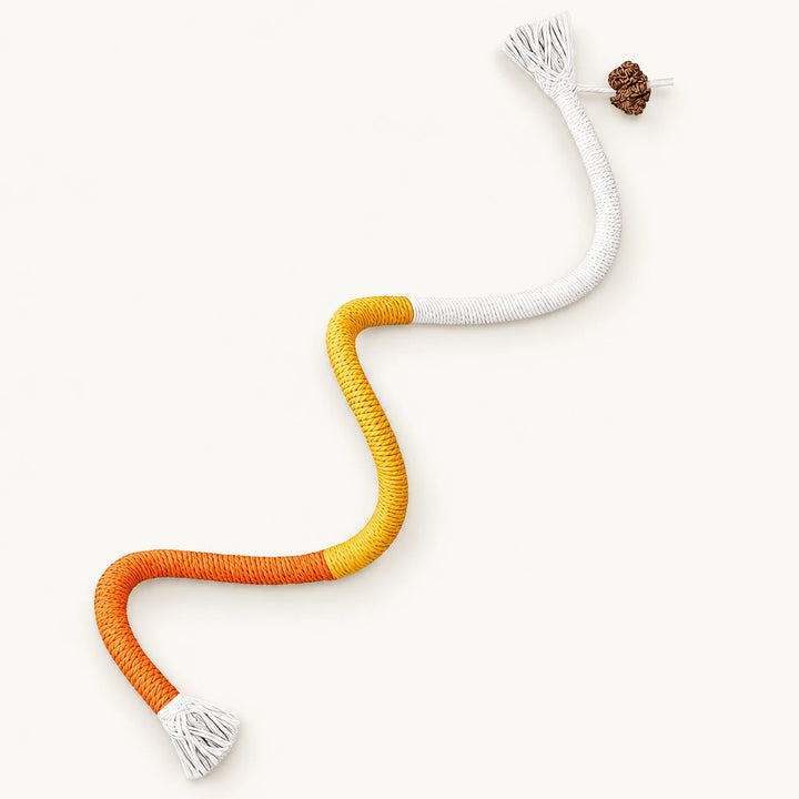 Orange, yellow and white cat rope toy with tassels — studio view